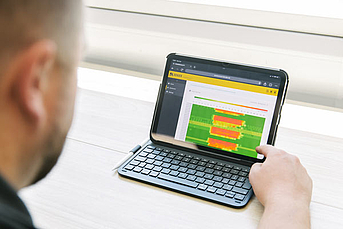 Bender engineer reviewing POWERSCOUT remote monitoring software showing a heatmap for energy usage.